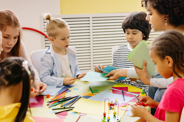 Group of children and educators doing craft activity