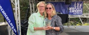 Kate Vines (left) with winner Cathy (right) smiling holding the trophy