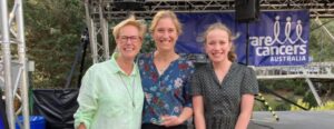 Three woment smiling together holding a trophy for the Kosi Challenge