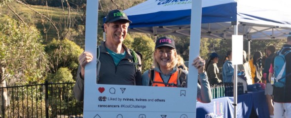 Two people smiling with an Instagram frame at the Kosi registration area