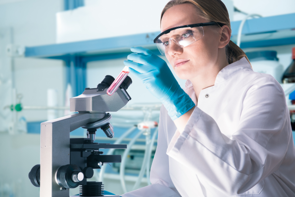 A researcher in a lab reveiws some blood work.