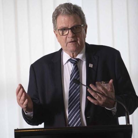 A man speaking at a lectern at a conference