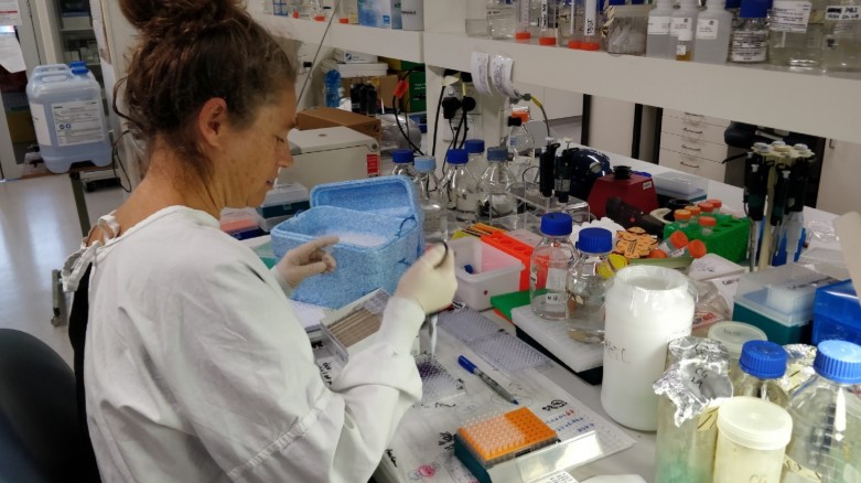 A woman in a lab coat testing